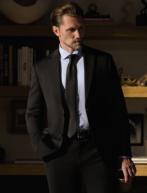 Man in a black suit and tie. Online only suits up to 50 percent off.