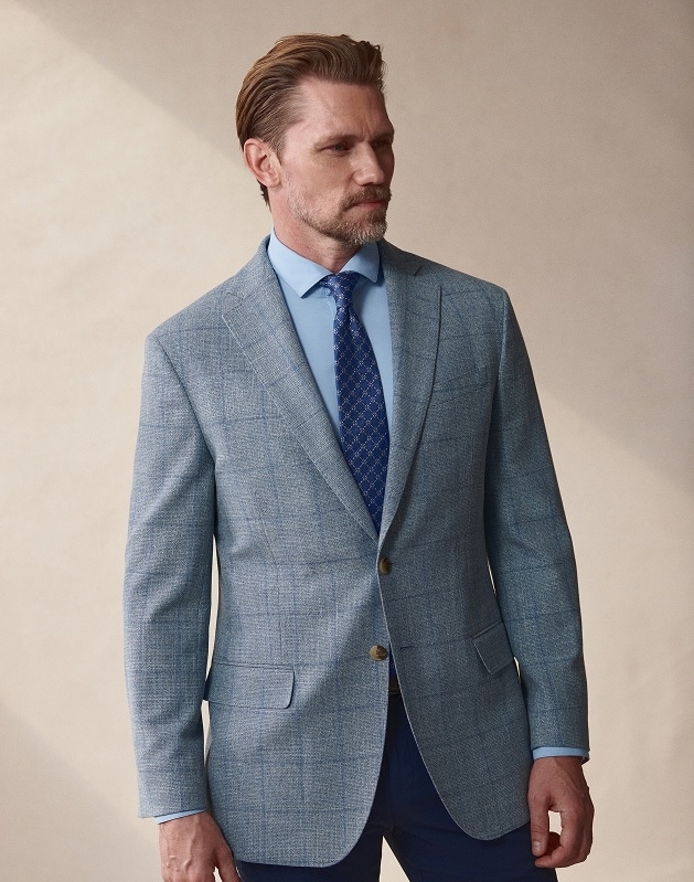 Man in a light blue sport coat and tie. Sport coats and blazers 30 percent off.