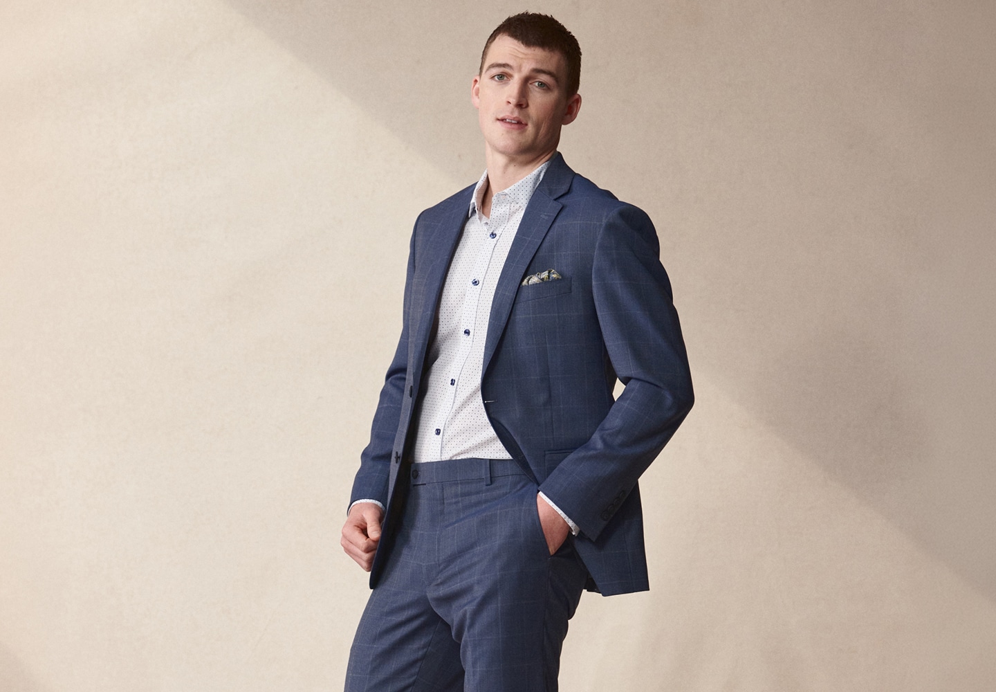 Man in a blue windowpane suit. Online only 30 percent off sitewide.