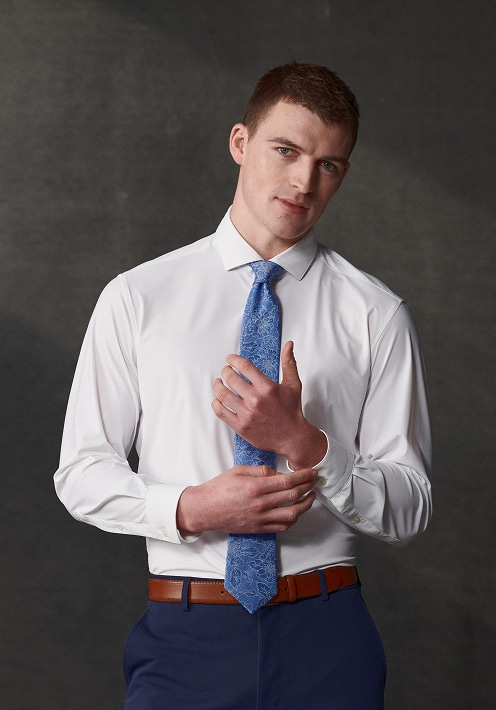 Man in a white dress shirt and blue tie. Dress shirts up to 30 percent off.