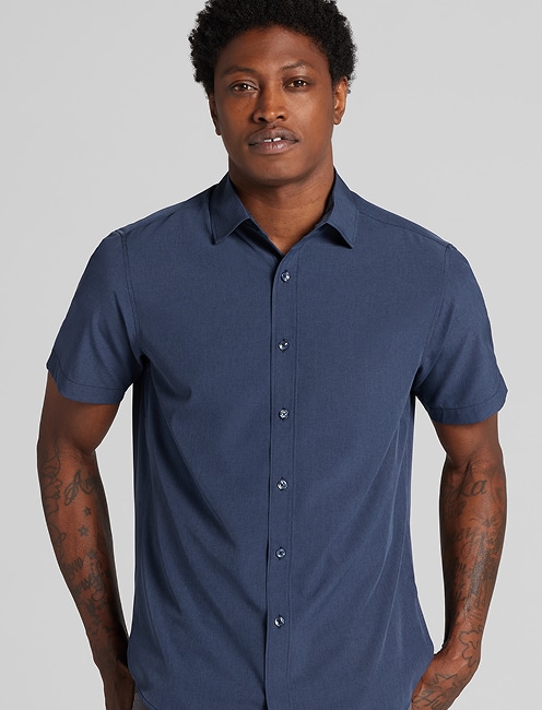 Man in a navy casual shirt. Casual shirts and layers 30 percent off.