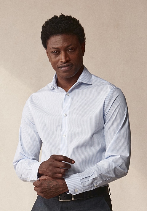 Man in a light blue dress shirt. Dress shirts 30 percent off.