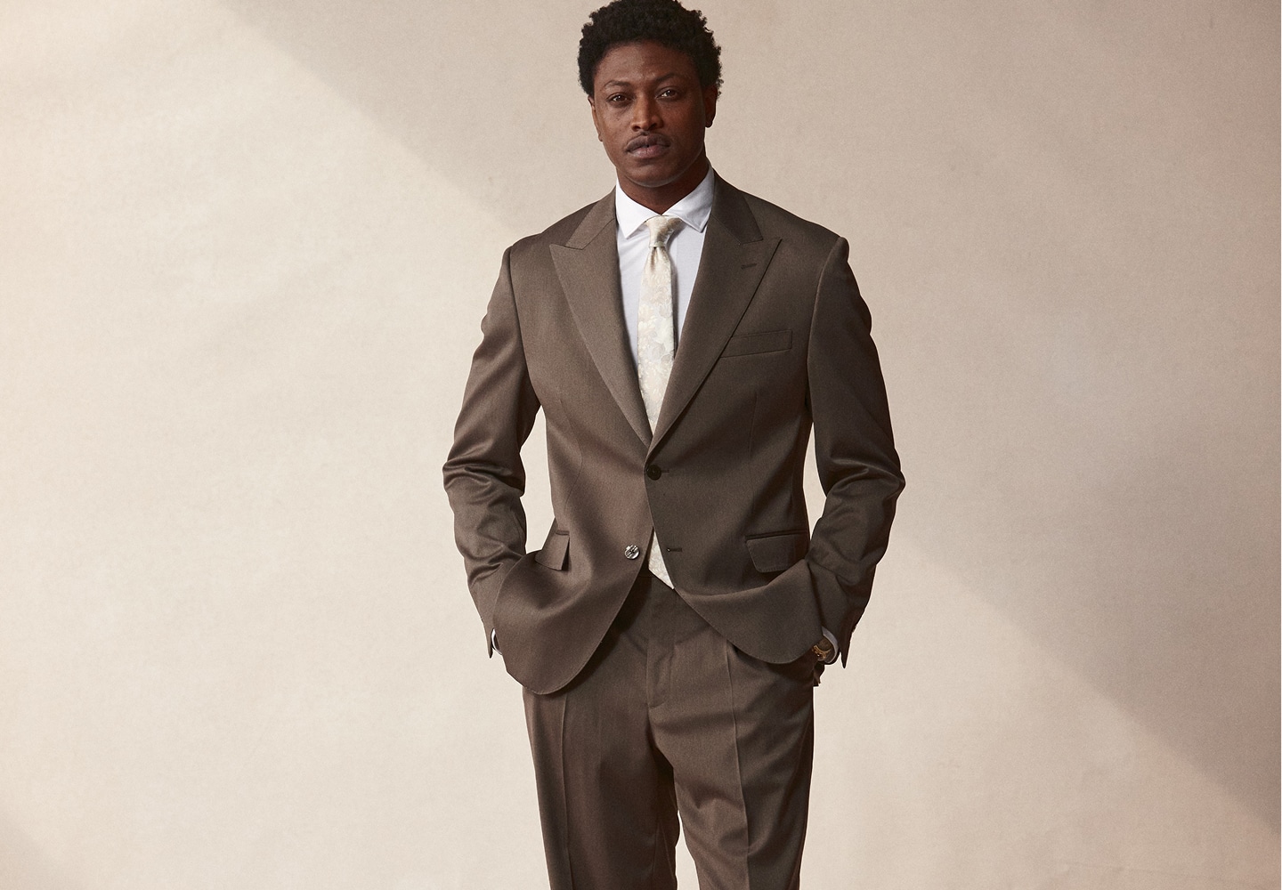 Man in a brown suit. Suits 30 percent off.