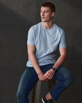 Man in a light blue t-shirt. Casual shirts up to 50 percent off.
