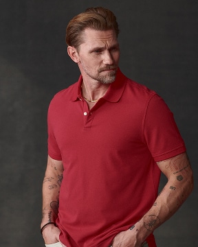 Man in a red polo shirt. Casual shirts and layers up to 50 percent off.