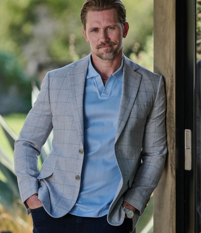 Man in a light blue polo and grey sport coat