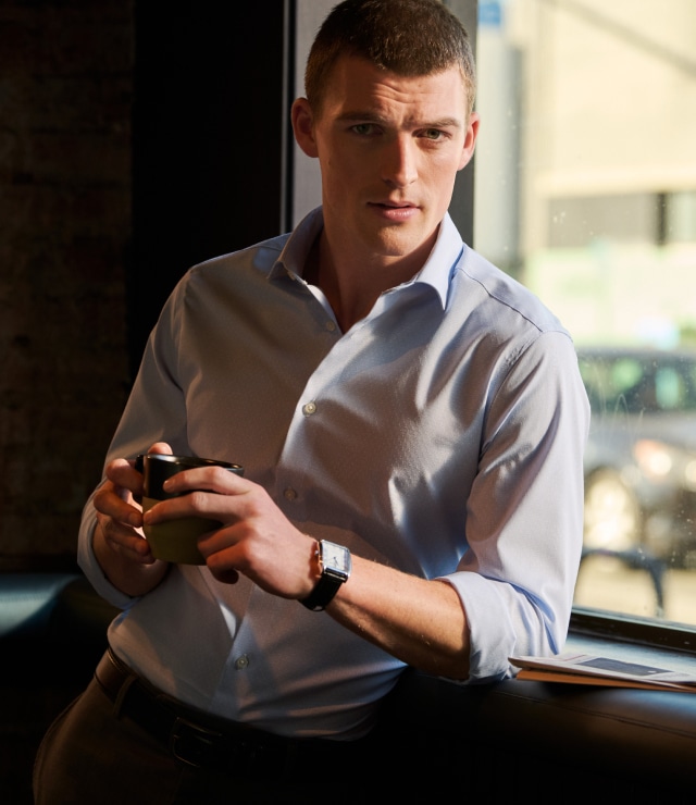 Man in a burgundy polo outdoors