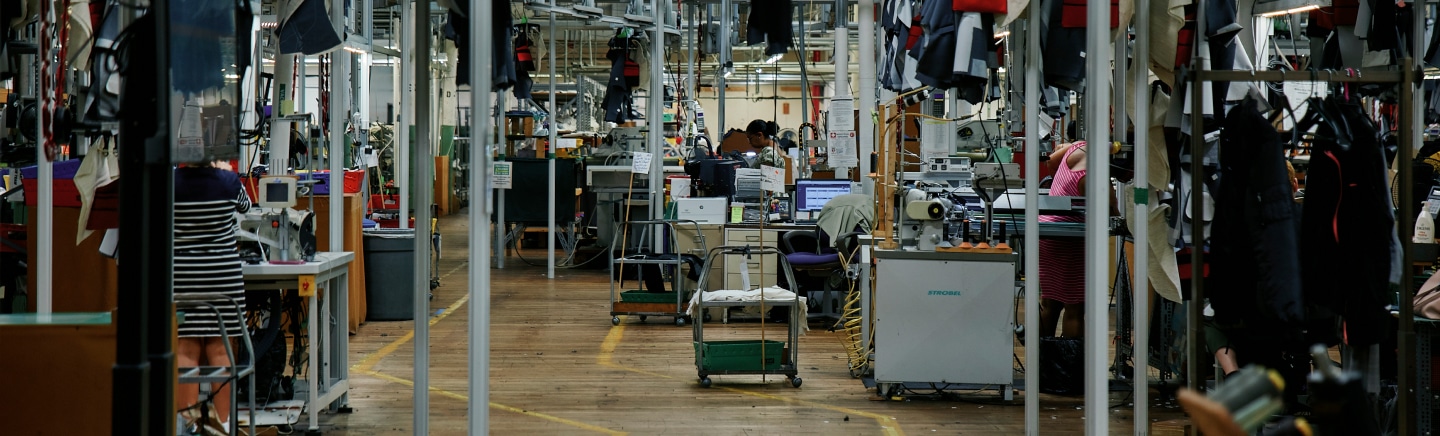 New Bedford factory floor with union craftspeople producing garments.