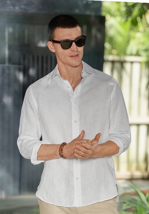 Man in a white linen shirt. Casual shirts 30 percent off.