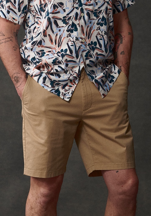 Man in khaki shorts. Jeans and shorts up to 40 percent off.