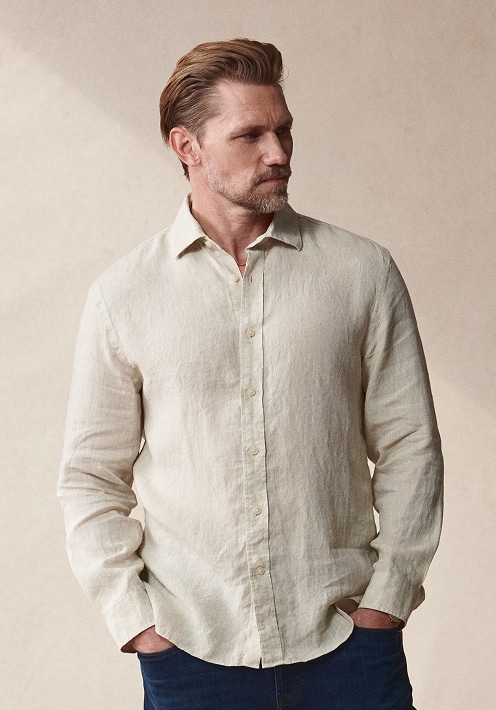 Man in a white linen shirt. Casual shirts up to 50 percent off.