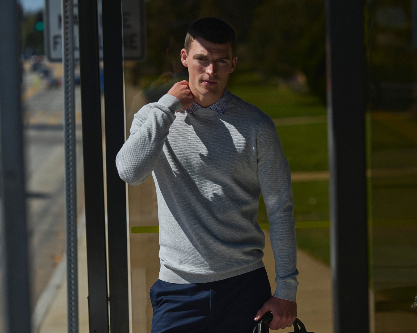 Man wearing a grey sweater.