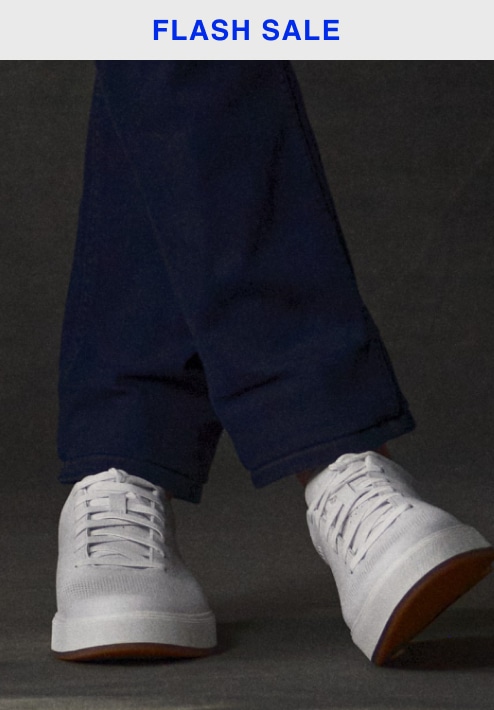 Flash sale. White sneakers with navy pants cuffed above the ankle. Shoes 30 percent off.