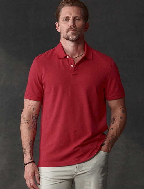 Man in a red polo shirt and khaki pants.
