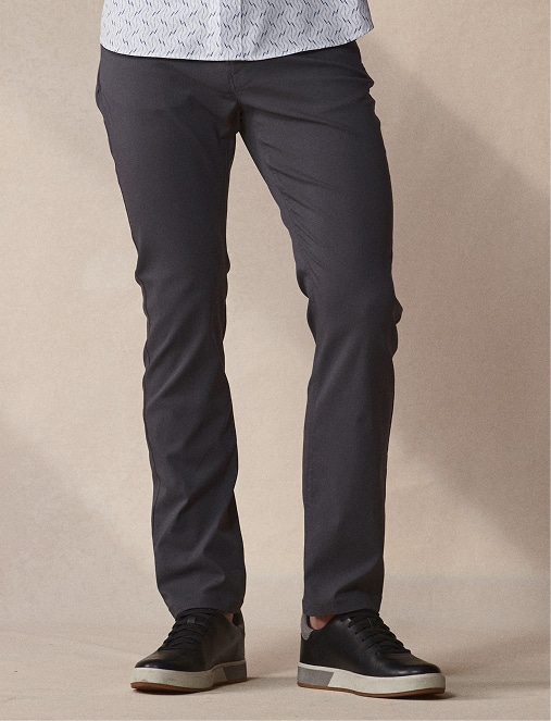 Man in dark grey pants and black sneakers.