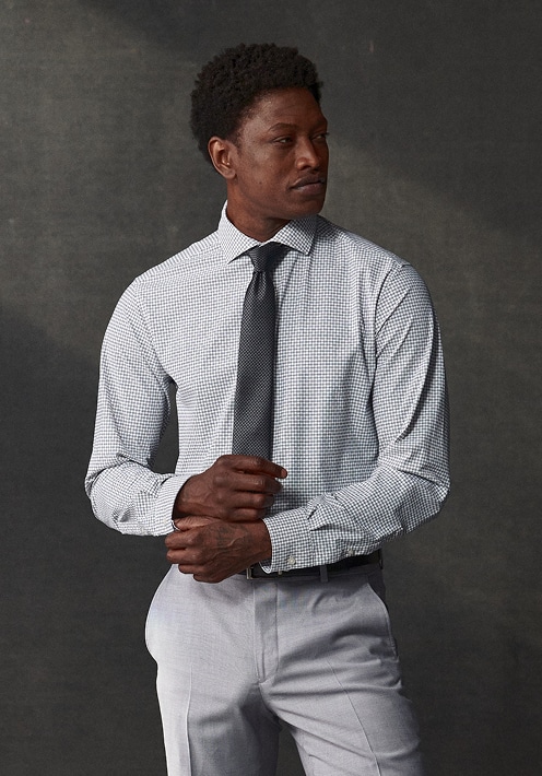 Man wearing a dress shirt and tie. Dress shirts 30 percent off.