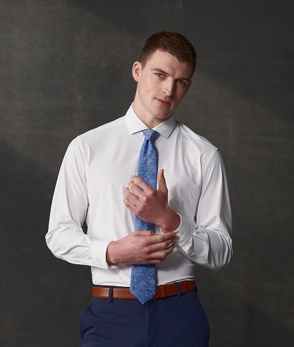 Man wearing a white dress shirt and blue tie.
