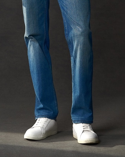 Blue jeans and white sneakers.