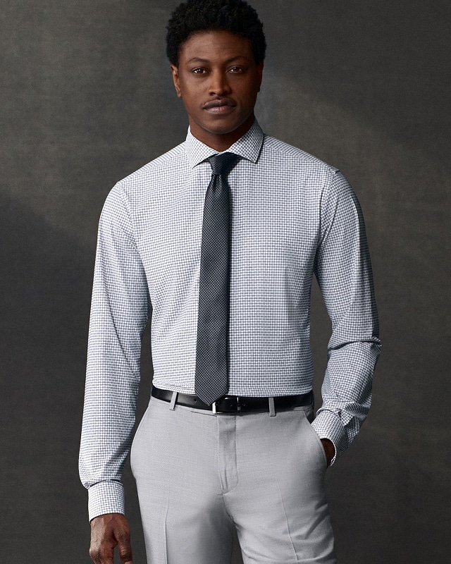 Man wearing a dress shirt and tie. Dress shirts buy 1 get 1 50 percent off.
