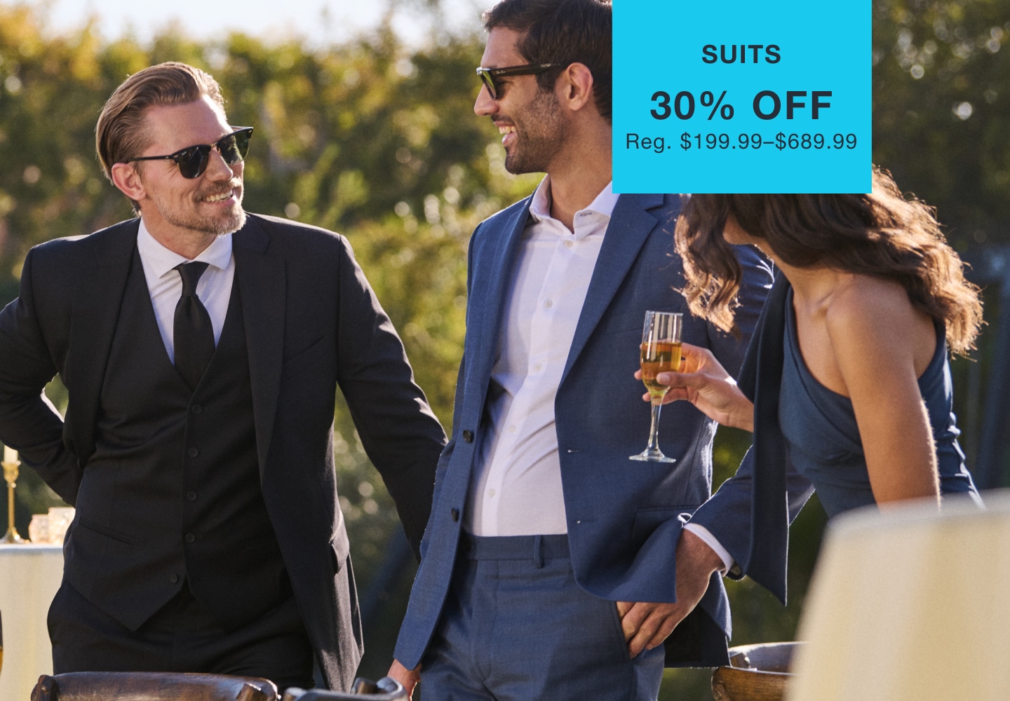 Men wearing suits at a wedding. Suits 30% off. Reg. $199.99–$689.99.