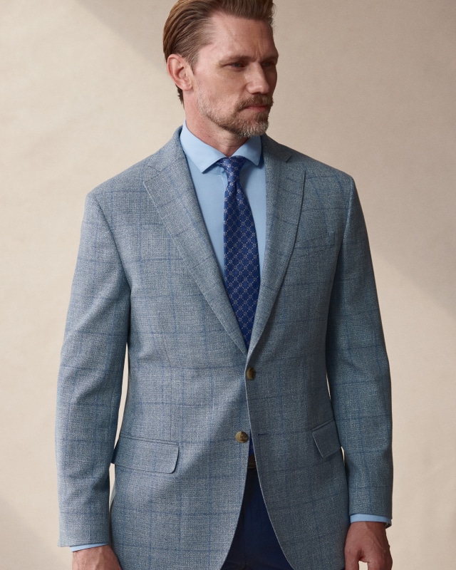 Man wearing a light blue sport coat.