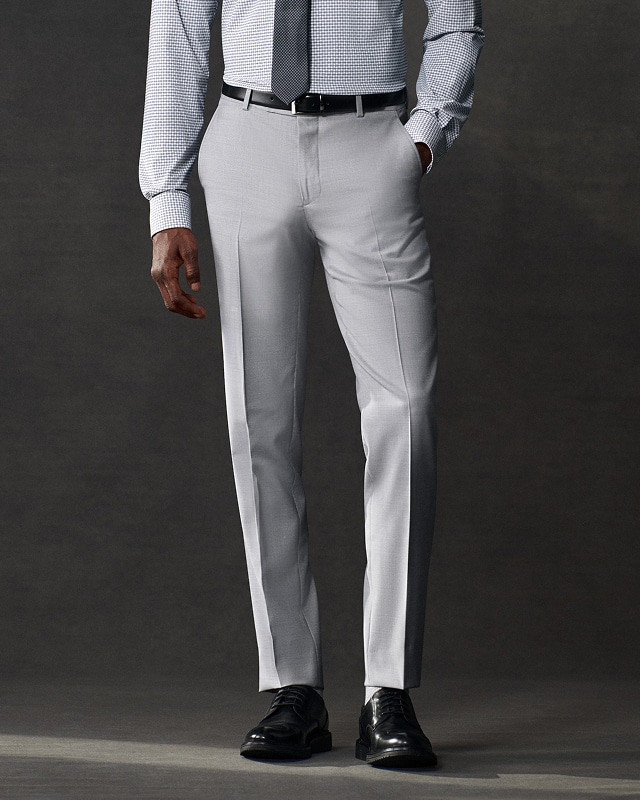 Man wearing light grey dress pants. Pants and shorts up to 50 percent off.