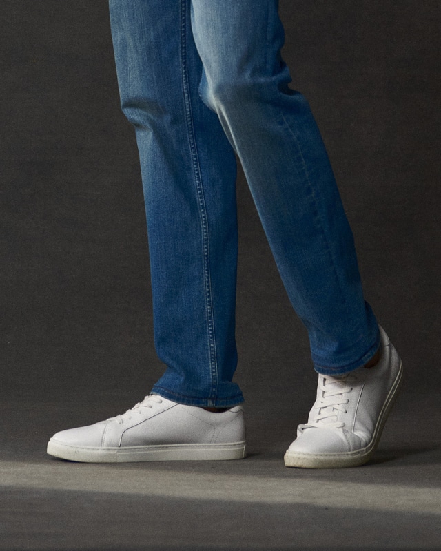 Blue jeans and white sneakers. Shoes 30 percent off.