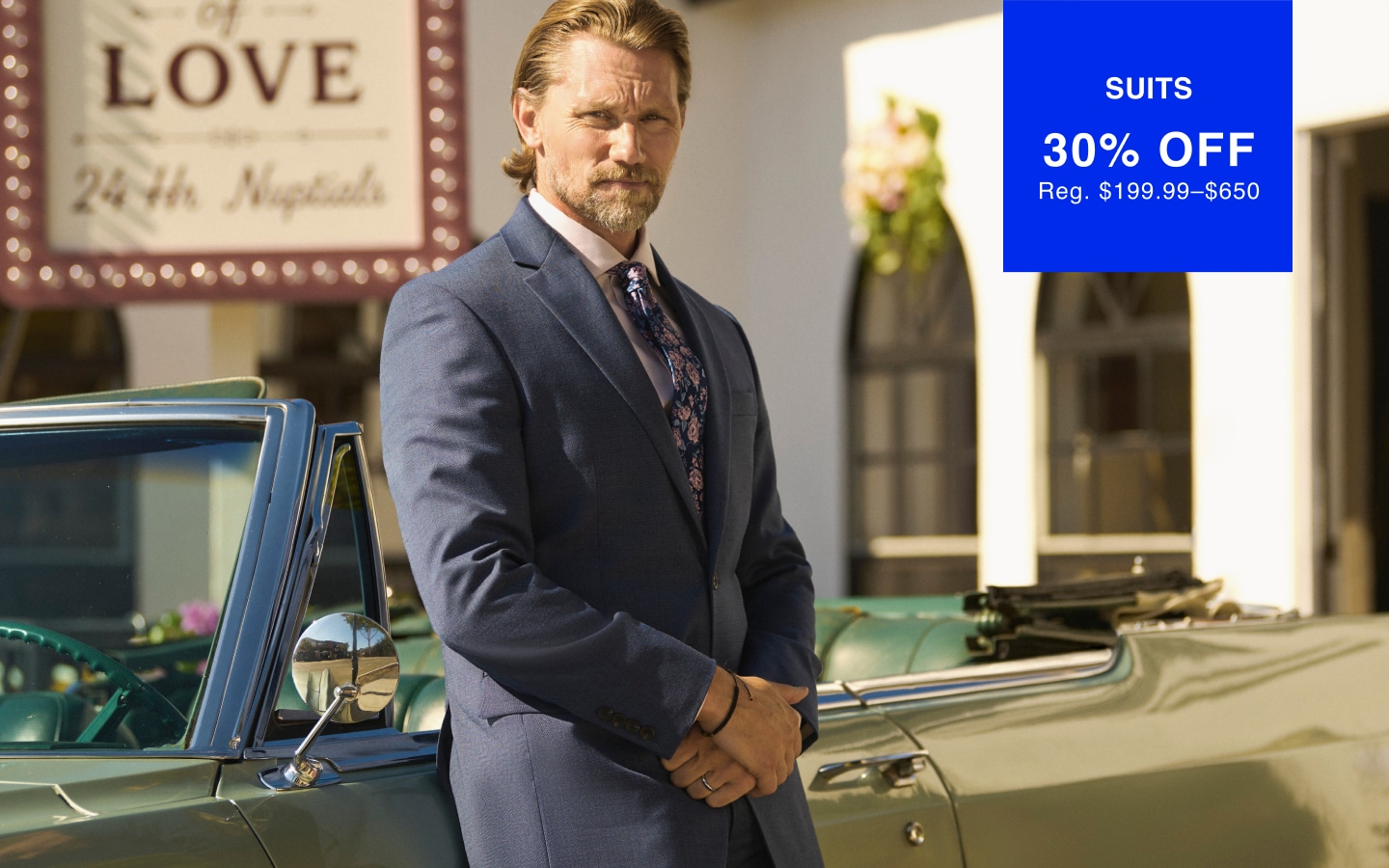 Man in a blue suit. Suits 30% off. Reg. $199.99–$650.