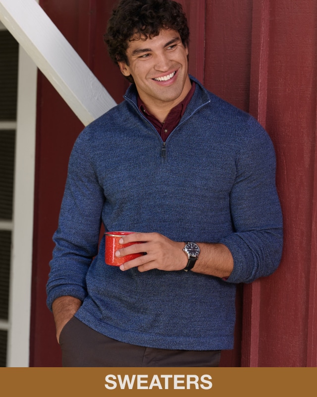 Man wearing a blue quarter-zip sweater. Casual wear.