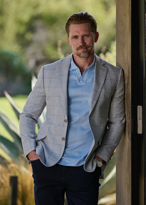 Man in a grey checked sport coat over a white dress shirt.