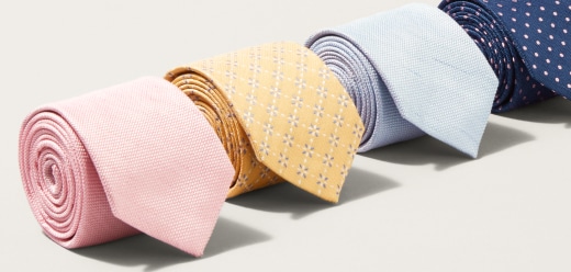 Rolled neckties in pink, yellow, light blue, and navy with polka dots