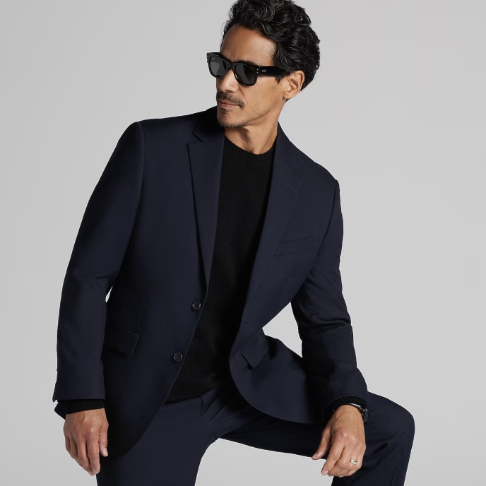 Man in a navy suit and sunglasses. Clearance suits.