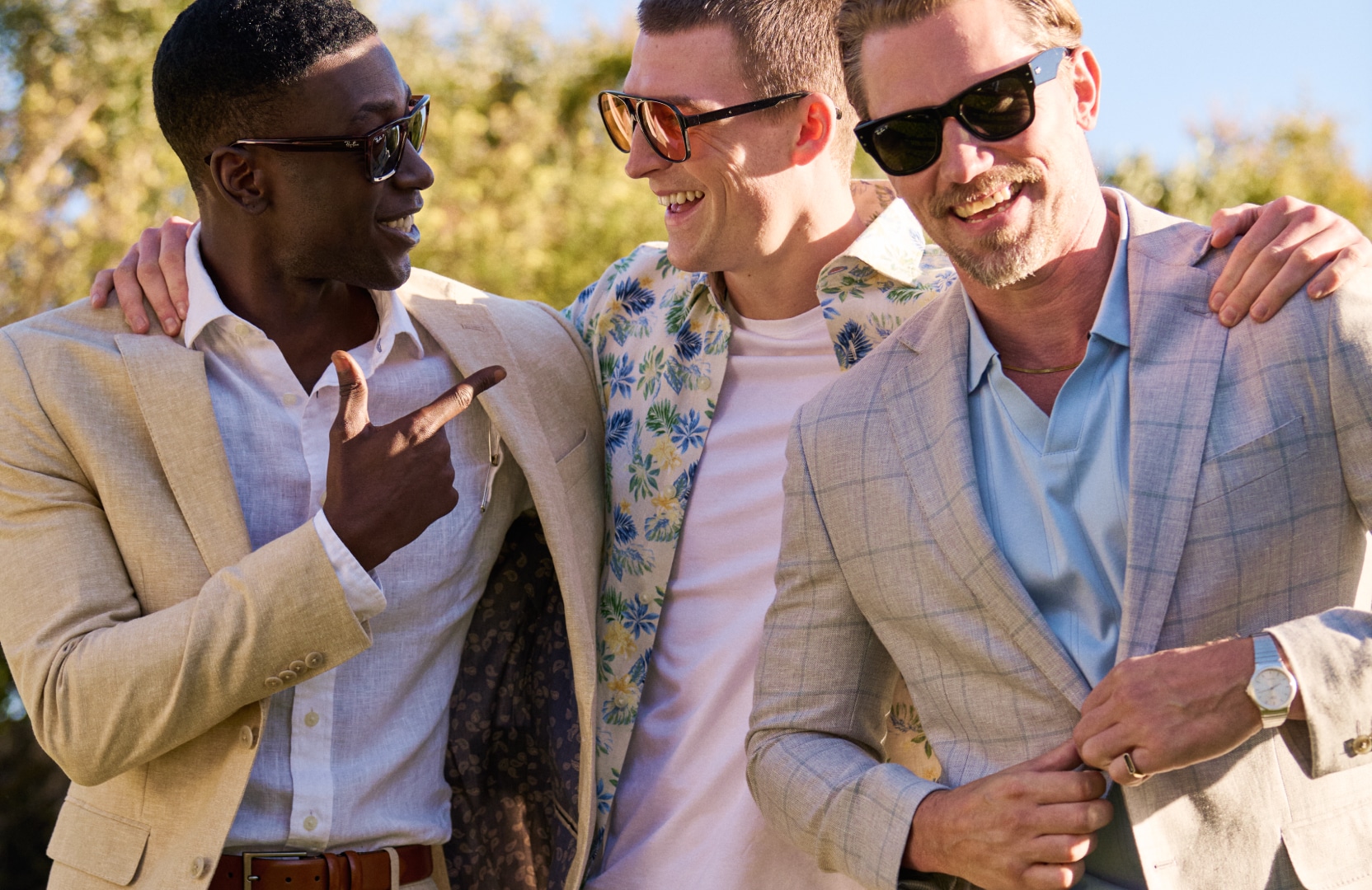 Three men outdoors in linen suits and summer clothing